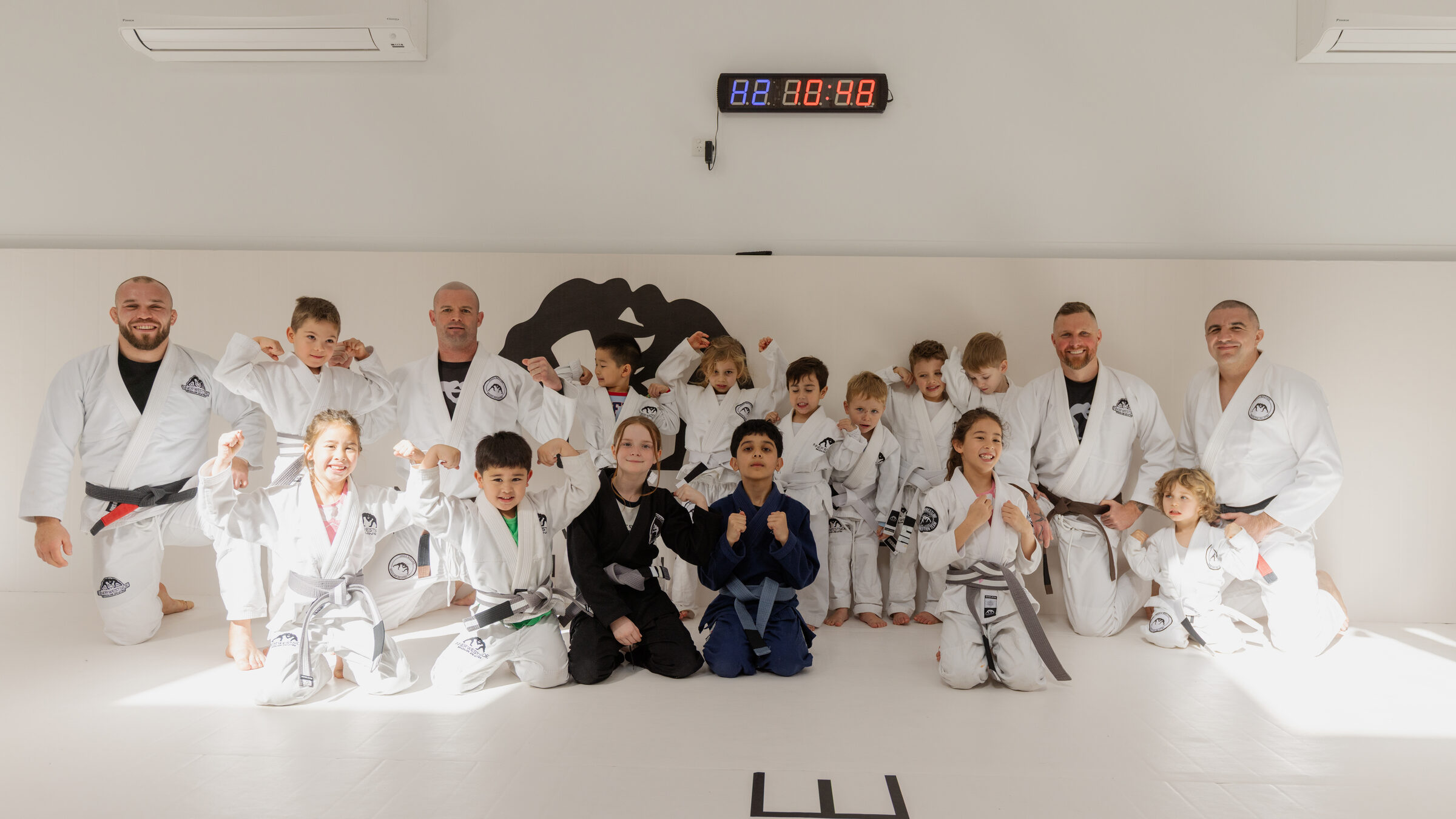 The Inner Westside BJJ kids class and coaches together on the mats